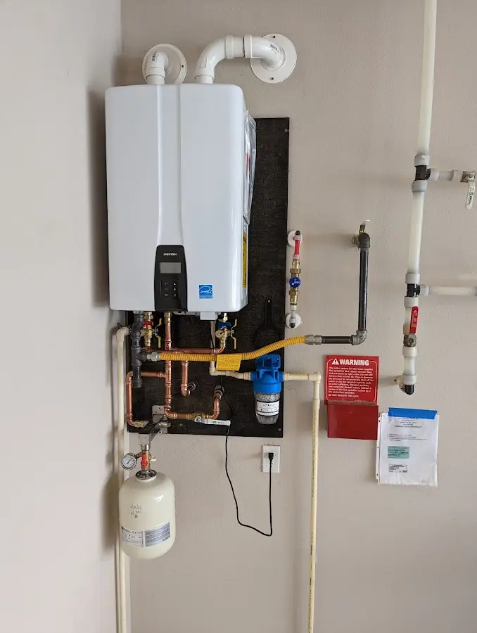 Professional plumber installing copper piping in a Chatham home
